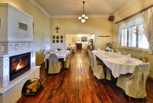 a large dining room with tables and a fireplace at Resort Stara Škola in Začretje