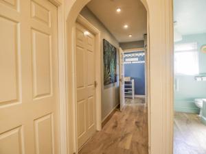a hallway with a door leading to a bathroom at Seaspray in St Bees
