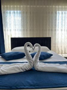 twee zwanen maken een hart op een bed bij Paradise House Hotel in Pamukkale
