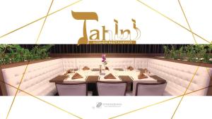 a restaurant with a table with chairs and a sign at International Hotel Casino & Tower Suites in Golden Sands