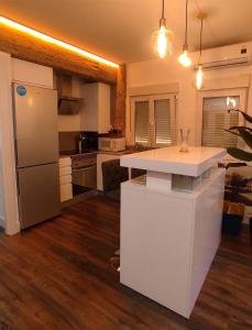 cocina con encimera blanca y nevera en Gran Reserva Suites centro alojamiento entero, en Logroño