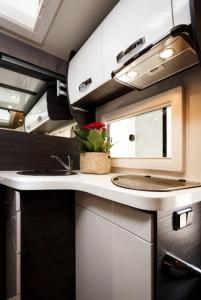 a kitchen with a sink and a counter top at Camper met sauna en zwembad in de rand van de Vlaamse Ardennen in Haaltert