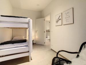 a bedroom with a bunk bed and a room with at Mooi Maaseik in Maaseik +6 photos