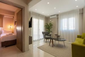 a bedroom with a bed and a living room at NK Luxury Apartments in Preveza
