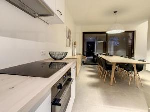 a kitchen with a table and a dining room at Mooi Maaseik in Maaseik