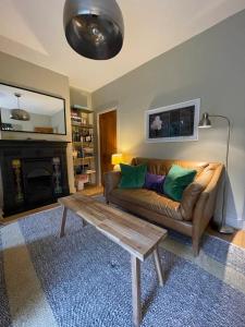 a living room with a couch and a coffee table at Beautiful & Cosy 2BD House - Southwark in London