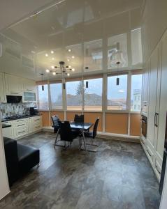 a large kitchen with a table and chairs in it at APARTMENT PREMIUM VIP in Berdychiv