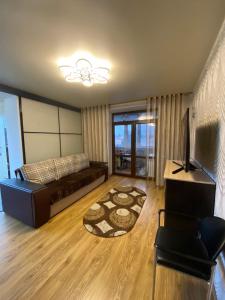 a large living room with a couch and a television at APARTMENT PREMIUM VIP in Berdychiv
