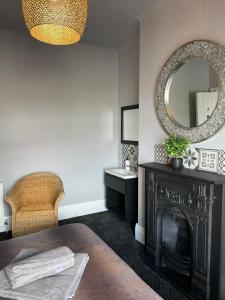 a living room with a fireplace and a mirror at The Vines Lodge in Cleethorpes