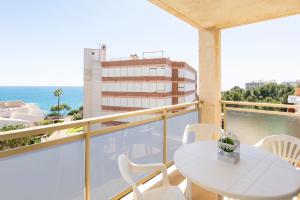 a balcony with a table and chairs and the ocean at Rentalmar Nabila in Miami Platja