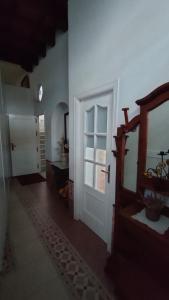 a hallway with a door and a mirror in a room at Casa Las Vidrieras in Puerto Real +10 photos