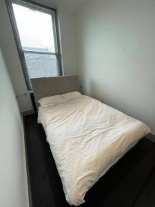a small bed in a room with a window at Stylish 1BD Flat - 1 Min from Bethnal Green in London