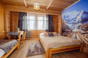 a bedroom with two beds and a painting on the wall at Apartament przy Wyciągu z jacuzzi in Bukowina Tatrzańska +104 photos