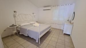 Postel nebo postele na pokoji v ubytování Apartmani Tolj
