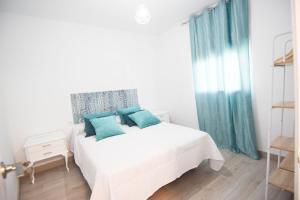 科爾多瓦的住宿－ATICO AGUAYOS con PARKING GRATIS，一间卧室配有白色床和蓝色枕头