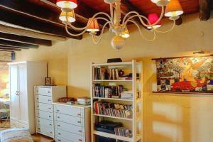 a room with a book shelf and a chandelier at Angela's House in Koumeika