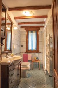 a bathroom with a toilet and a sink at [Sea Garden] Elegant Villa with a View in Rio nellʼElba