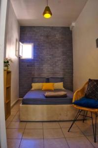 a bedroom with a bed with a brick wall at Appartement 1er arrondissement in Marseille