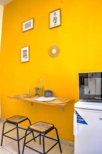 a kitchen with two stools and a counter with a microwave at Appartement 1er arrondissement in Marseille