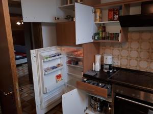 a refrigerator with its door open in a kitchen at Karl-Stieler-Straße in Bruckmühl