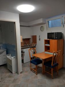 una cocina con mesa y 2 sillas y una cocina con fregadero en Residence Sole Dell'Argentario, en Porto Santo Stefano
