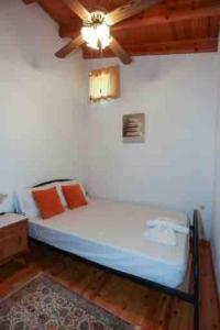 a bed in a room with a ceiling at “ Nicolas traditional house” in Gardeládes