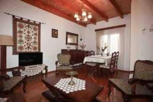 a living room with a piano and a table at “ Nicolas traditional house” in Gardeládes