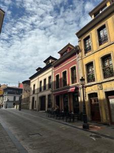 a group of buildings on the side of a street at La Estación in Avilés