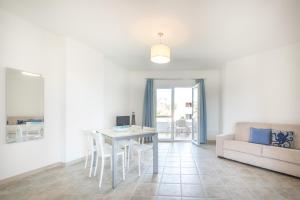 una sala de estar con una mesa y un sofá en Casa Fischio, en Castelsardo