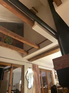 a living room with wooden beams and a ceiling at Między Wodami in Węgorzewo