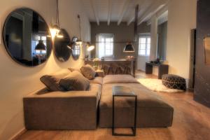 a living room with a couch and a mirror at Urban Central Suites in Cagliari