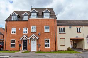 a large red brick house with a white door at Evergreen House - Modern 4-bed Family, Contractors, Free Netflix, Fast WiFi, NEC, Resorts World, JLR, Airport in Solihull