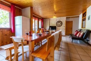 eine Küche und ein Wohnzimmer mit einem Holztisch und einem Kühlschrank in der Unterkunft Appartement de 4 chambres a Saint Sorlin d'Arves a 100 m des pistes avec balcon et wifi in Saint-Sorlin-dʼArves