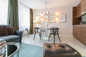 a living room with a couch and a table at HeyMi Apartments Mondschein in Vienna