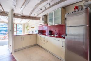 a large kitchen with a stainless steel refrigerator at IZARO Best View in Bermeo +6 photos