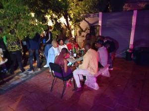 a group of people sitting on chairs at a party at Munach Guest Lodge in Benoni