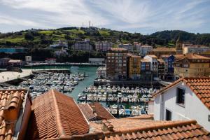 a view of a harbor with boats in the water at IZARO Best View in Bermeo