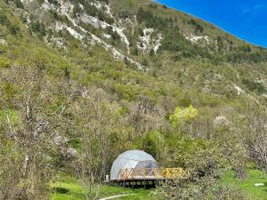 a dome tent sitting in front of a mountain at Bali Glamping in Ambrolauri