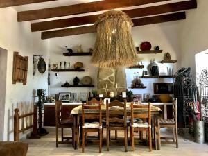 a dining room with a table and chairs and a chandelier at Villas Ahumada. Chalet La Ahumada in Tarifa