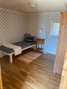 a bedroom with a bed and a table in a room at Sun Slottet in Stockholm