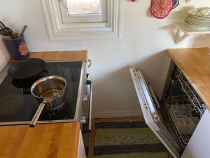 a kitchen with a stove with a pot in the oven at Sun Slottet in Stockholm