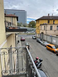 a balcony with a view of a city street with cars at Margarita Apartment Stazione Porta Susa Torino in Turin