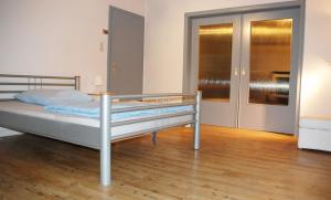 a bedroom with a bed and a wooden floor at Ferienwohnung Schmäing, Haiger/Westerwald / Rothaarsteig in Haiger +11 photos