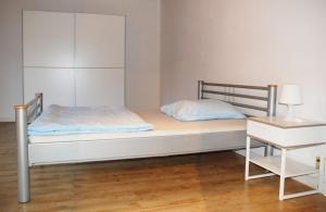 a small bedroom with a bed and a night stand at Ferienwohnung Schmäing, Haiger/Westerwald / Rothaarsteig in Haiger