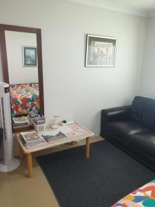 a living room with a table and a couch at Telperio - Guest suite max 4 Guests in Bunbury