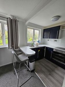 a small kitchen with a table and chairs in it at Entire Spacious Modern One Bedroom House in Swindon