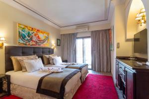 Postel nebo postele na pokoji v ubytování Le Caspien Boutique Hotel + 37 fotografií