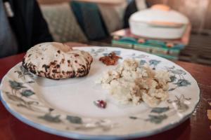 a white plate with cookies on a table at RezangLa Homestay in Chushul