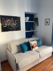 - un canapé avec des oreillers dans le salon dans l'établissement Margarita Apartment Porta Susa Torino, à Turin