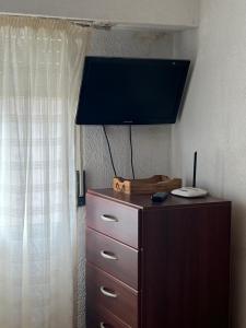 a dresser with a television on top of it at Aconcagua in Miramar